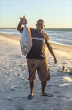 Malagasy fisherman showing his catch