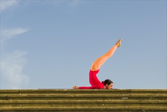 Young woman practising Hatha yoga