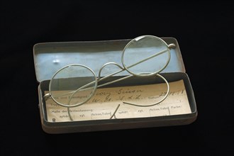 Service glasses from 1938 with a sheet metal case and a property slip on black