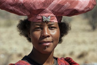 Native Herero woman with typical hat in Uis