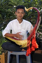 Burmese man playing the Saung Gauk