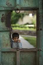 Little boy at a gate of the City Palace