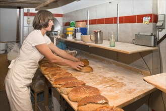 Farmer making bread in her own bakery on the farm