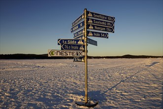 Signpost on the frozen Lake Inari