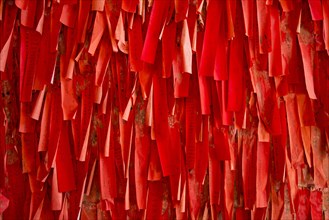 Red luck or wishing papers on a wall in the temple