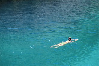 Woman swimming in the turqouise Mediterranean Sea