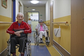 Two senior citizens in wheelchairs