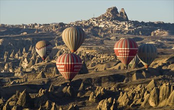 Hot air balloons in front of the Castle of Uchisar