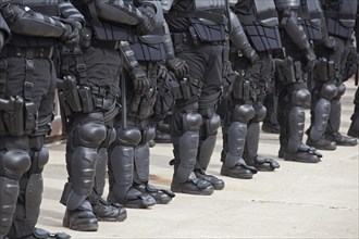 Police in riot gear protecting members of the neo-Nazi National Socialist Movement as they hold a rally on the steps of the government office building