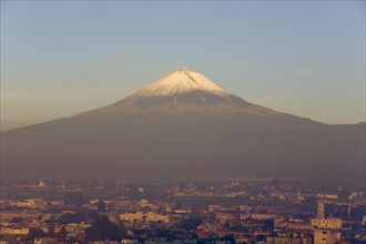 Popocatepetl volcano with the city of Cholula in early morning light