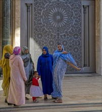 Moroccan women in front of the mosque Hassan II