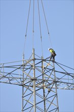 Overhead lineman working on a pylon