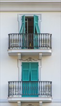 Balconies with turquoise shutters