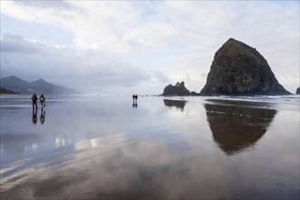 Clouds are reflected on the beach of Cannon Beach