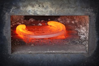 Red-hot horseshoe in the furnace of a blacksmith