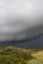 Dramatic storm clouds over dunes