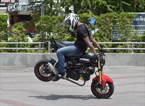 Motorcycle stunt rider performing