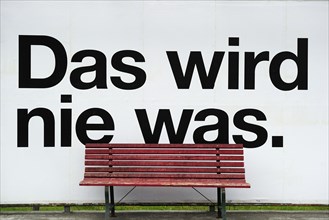 Bus stop that says ""Das wird nie was"" or ""that'll never work""