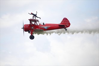 Wing walker on a biplane at an air show