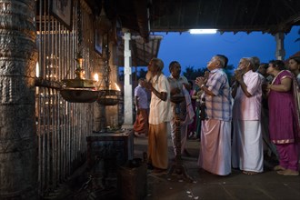 Hindus at evening prayer by the temple