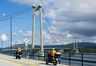Motorcycles on the European Road E39 at Stord Bridge or Stordabrua suspension bridge across the sound of Digernessundet