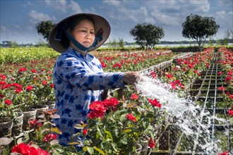 Worker watering flowers