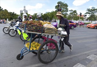 Greengrocer pushing his cart along the street