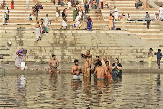 Devotees in ritual ablutions on the banks of the Ganges