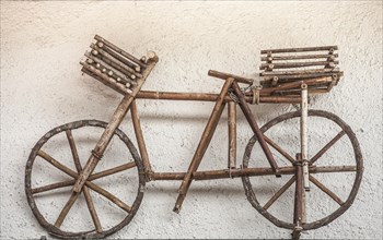 Wooden bicycle installation on a house wall