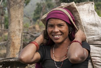 Nepalese farmwoman carrying a full bag