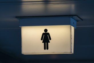 Lit restroom sign for women