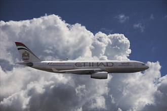 A6-EYK Etihad Airways Airbus A330-243 in flight against a cloudy sky