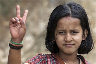 Nepalese girl making victory sign