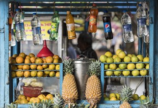 Drinks and fruit for sale at a stand