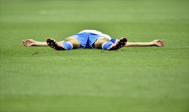 Injured football player lying on the ground