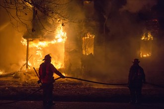 Firefighters battle a fire which destroyed a vacant home in Detroit's Morningside neighborhood