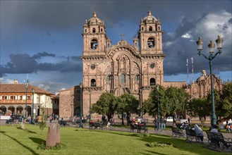 Place Plaza de Armas with the church Iglesia La Compania de Jesus at cloudy sky