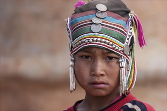 Girl of the Akha ethnic group with traditional headdress