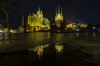 Erfurt Cathedral and Church of St. Severus at night with reflection in a puddle