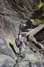 Young man on a hiking trail in the Caldera de Taburiente