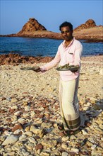 Man presenting fresh shrimps