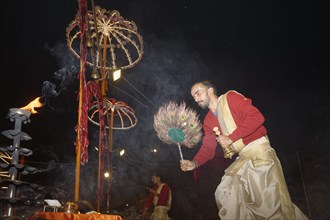 Priest celebrating the Aarti by offering incense