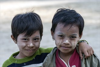 Two children with Thanaka paste on their faces