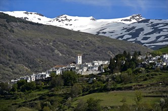 The village of Bubion at the foot of the snow-capped peaks of the Sierra Nevada