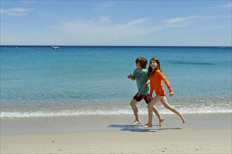 Children running on the beach