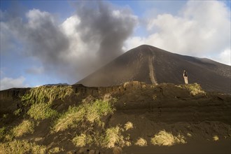 Person in front of Mount Yasur volcano