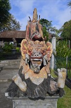 Seated dragon figure at the Tirta Gangga Water Temple