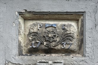 Guild sign above the entrance of the former Wolfsgrubermuhle