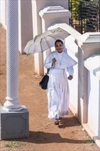 Smiling nun with parasol