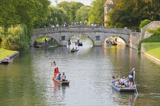 Punting on the river Cam with Clare Bridge in the distance